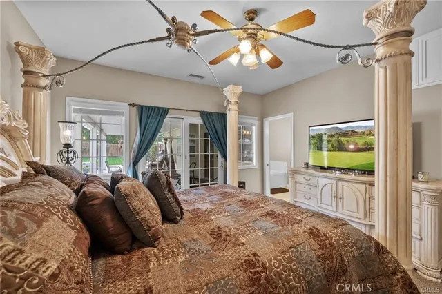 a bedroom with a large bed and a flat screen tv