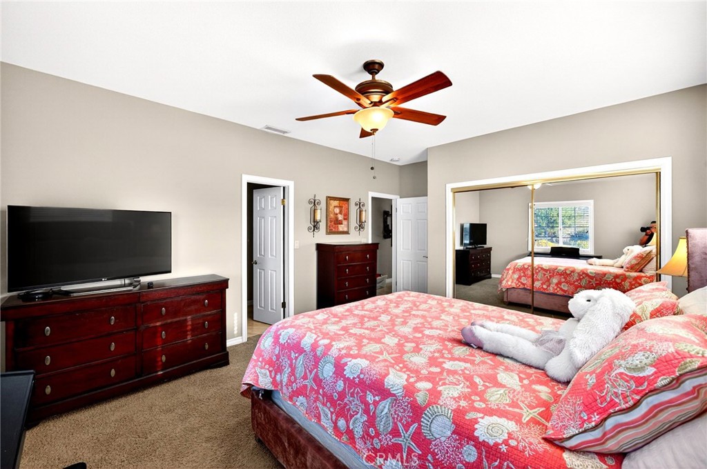 39581 Sperry Court Temecula, CA 92591 - Photo 38 of 63 a bedroom with a large bed and a flat screen tv