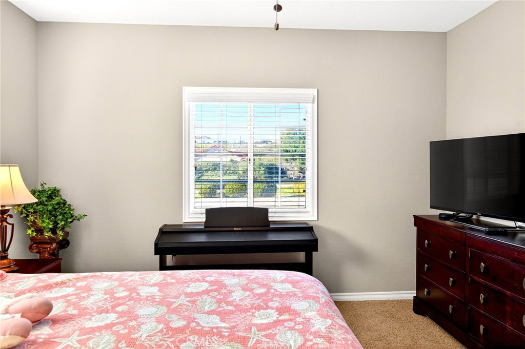39581 Sperry Court Temecula, CA 92591 - Photo 40 of 63 a bedroom with a bed and a flat screen tv