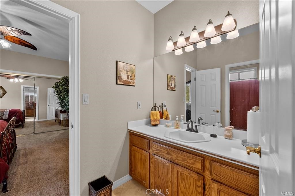 39581 Sperry Court Temecula, CA 92591 - Photo 42 of 63 a bathroom with a sink vanity and a mirror