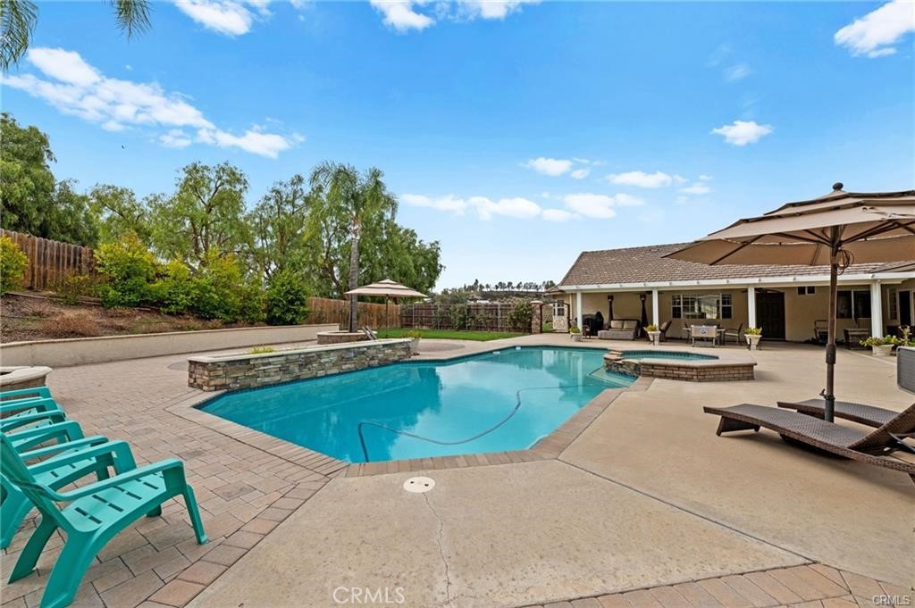 39581 Sperry Court Temecula, CA 92591 - Photo 47 of 63 a view of a swimming pool with lounge chairs in patio