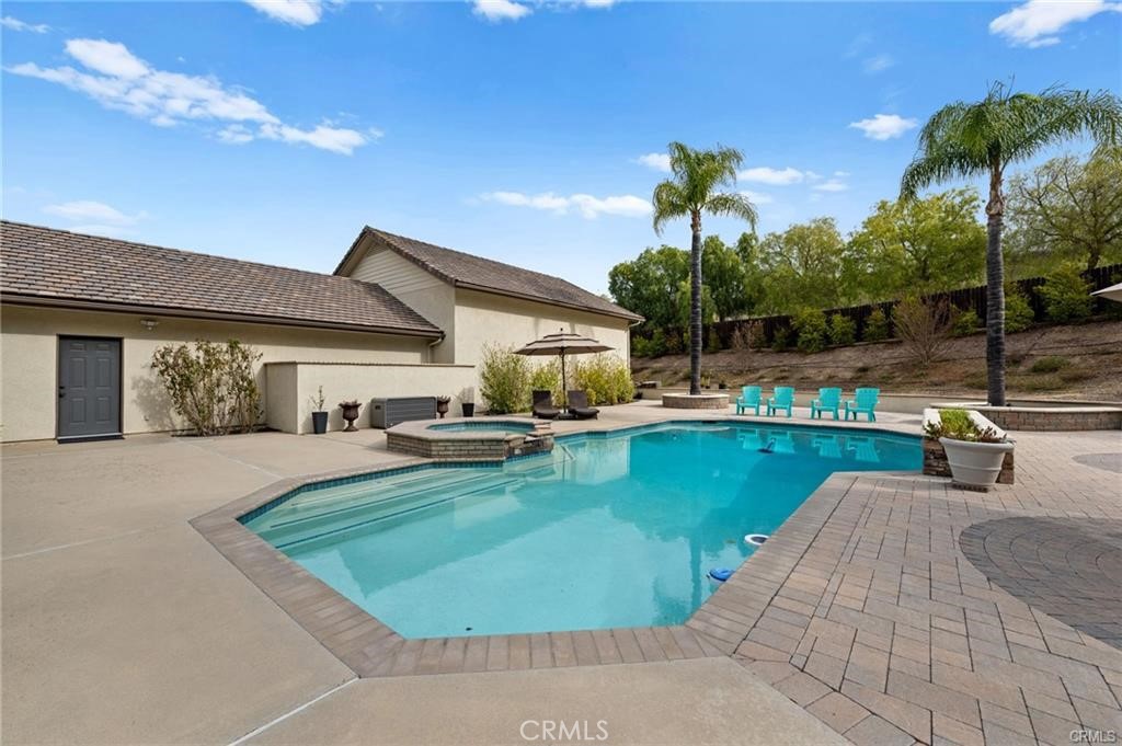 39581 Sperry Court Temecula, CA 92591 - Photo 49 of 63 a view of a patio with swimming pool table and chairs