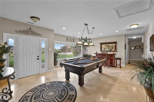 a living room with furniture a chandelier and a fireplace