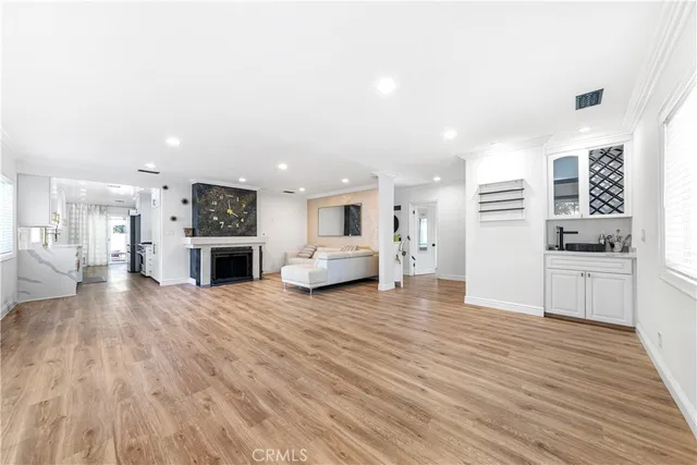 a view of a kitchen with a sink a refrigerator and cabinets