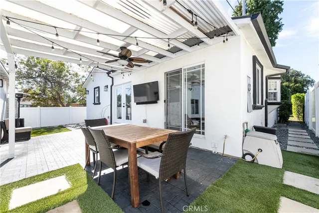 a view of a patio with a table and chairs