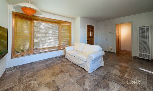 428 North Warner Street Ridgecrest, CA 93555 - Photo 4 of 21 a spacious bedroom with a bed and a large window