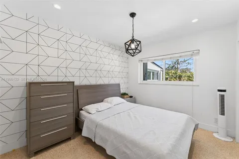 a bedroom with a bed and a ceiling fan