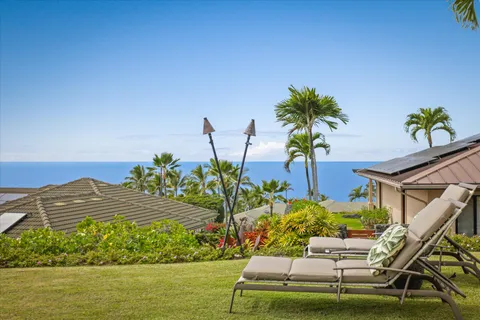 a view of a house with a yard and sitting area