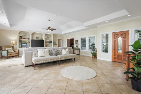a living room with furniture and dining table