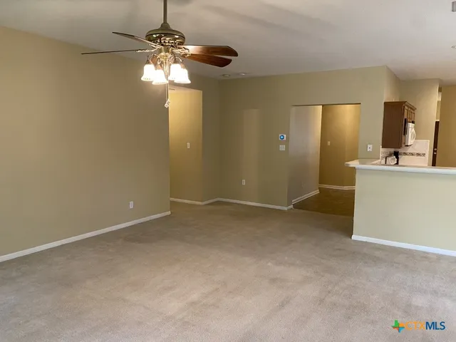 a view of a livingroom with a chandelier fan