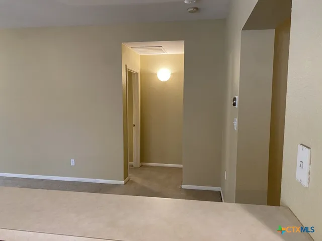 a view of a room that has a bed and a window