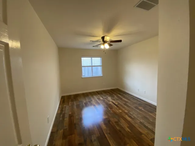 a view of an empty room and wooden floor