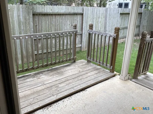 a kitchen with a sink and a stove top oven with wooden floor