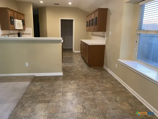 a bathroom with a double vanity sink mirror and toilet