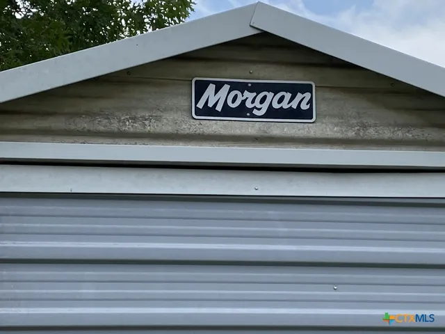 a view of a balcony with floor to ceiling window and wooden fence