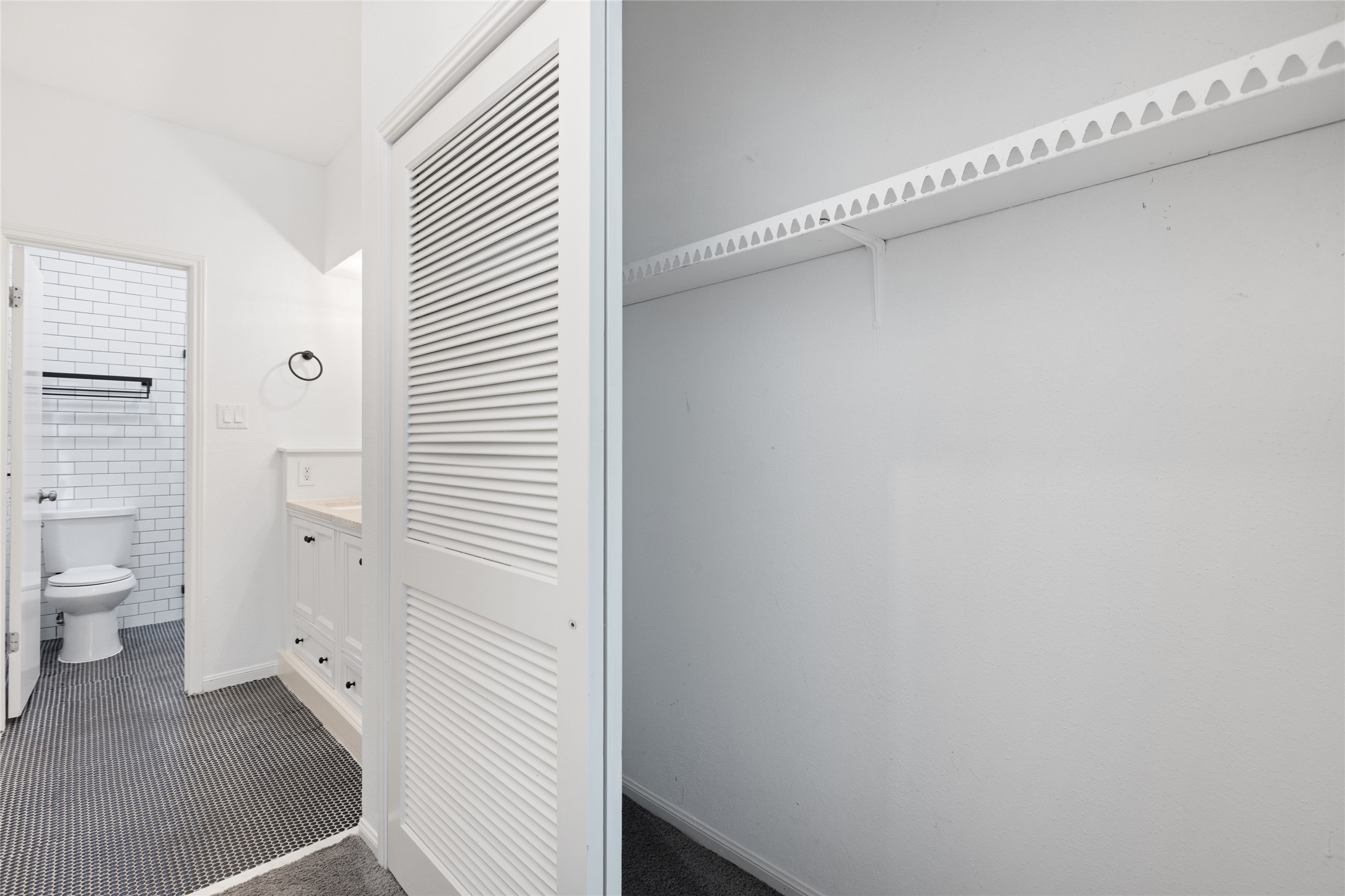 2100 Tanglewilde Street, Unit 378 Houston, TX 77063 - Photo 22 of 25 Peek-a-boo closet with ensuite bathroom. Because your clothes deserve bathroom proximity too.