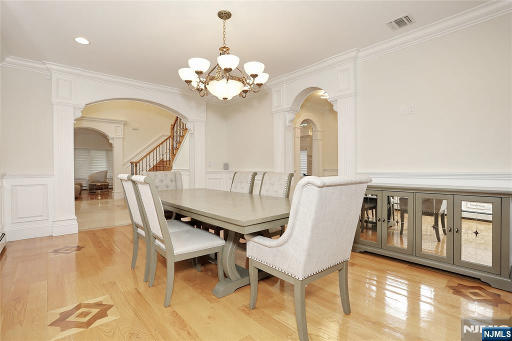 65 Ross Avenue Demarest, NJ 07627 - Photo 7 of 48 a view of a dining room with furniture a chandelier and wooden floor