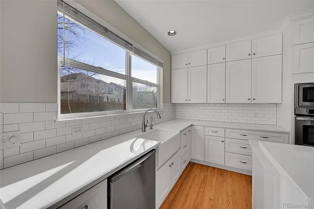 a kitchen with a sink stove and cabinets