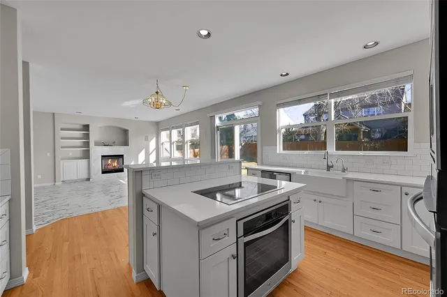 a kitchen that has a sink and a stove in it