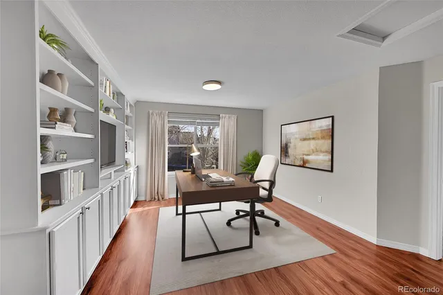 a workspace with furniture window and wooden floor