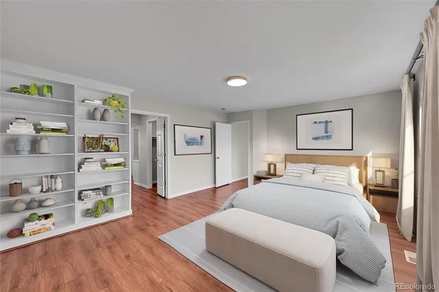 a bed room with a bed and a wooden floor