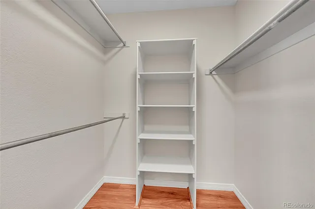 a view of walk in closet with empty racks