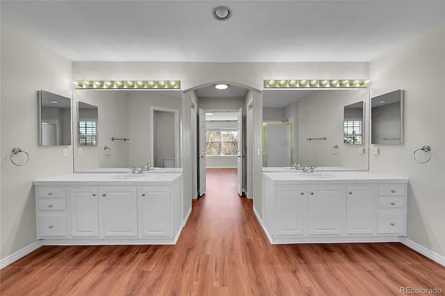 a spacious bathroom with a double vanity sink and a mirror