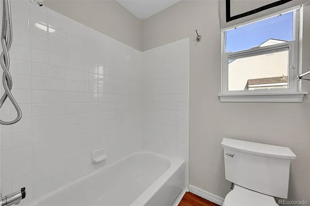 a bathroom with a toilet and a bathtub
