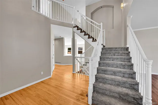 a view of entryway and hall with wooden floor