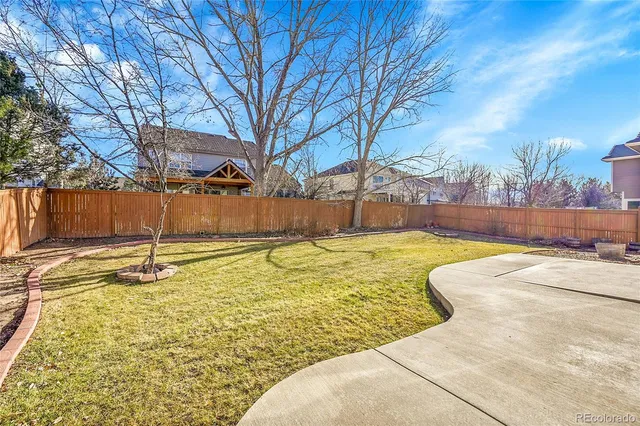 a swimming pool with outdoor seating and yard