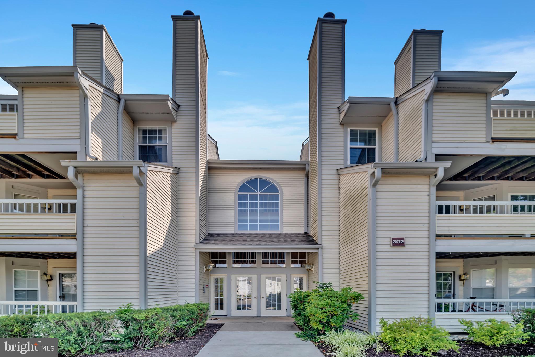 a front view of a building with garden