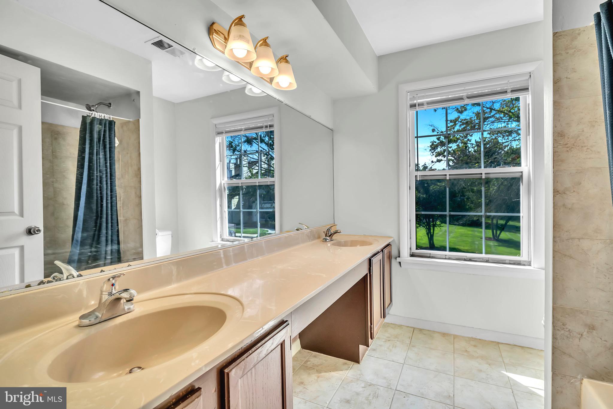 302 Trinity Court, Unit 8 Princeton, NJ 08540 - Photo 11 of 17 a bathroom with a granite countertop sink and a large mirror