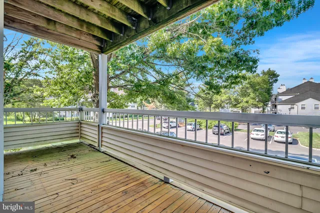 a view of a balcony with wooden floor