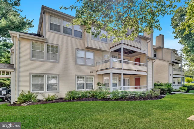 a front view of a house with a garden and yard