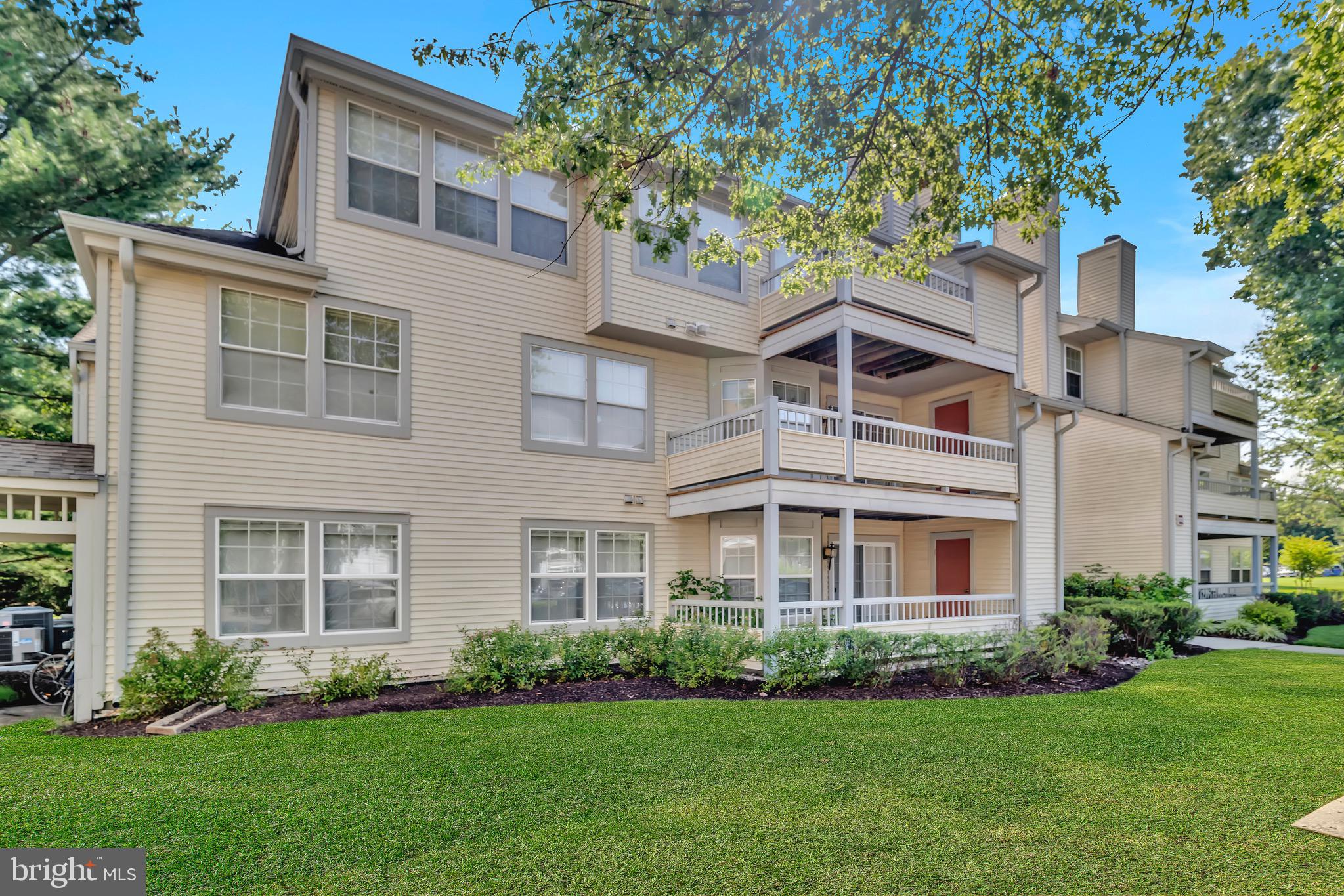 302 Trinity Court, Unit 8 Princeton, NJ 08540 - Photo 16 of 17 a front view of a house with a garden and yard