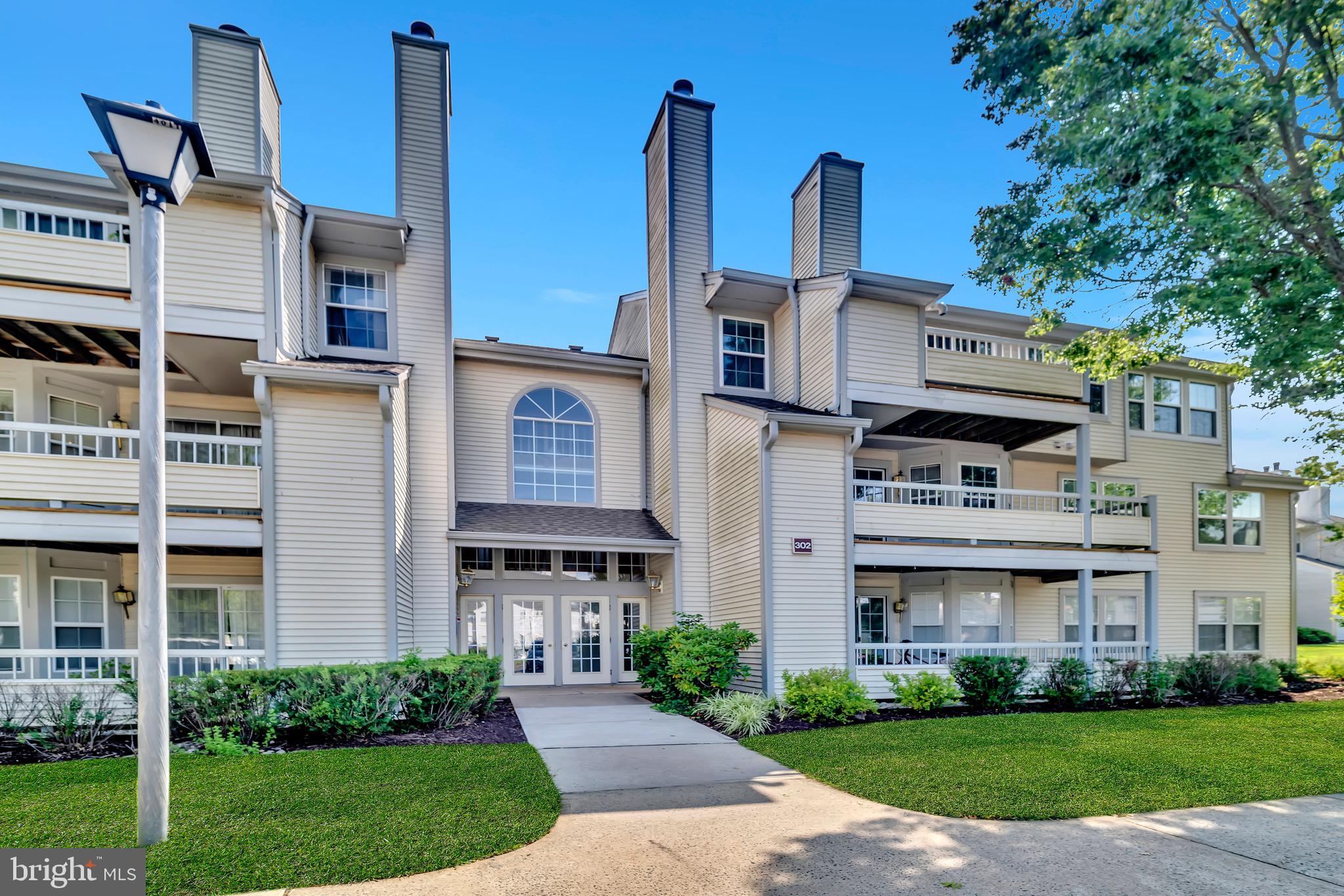 302 Trinity Court, Unit 8 Princeton, NJ 08540 - Photo 2 of 17 a view of a building with a yard