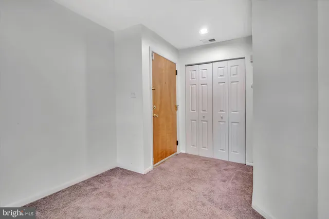 an empty room with closet area