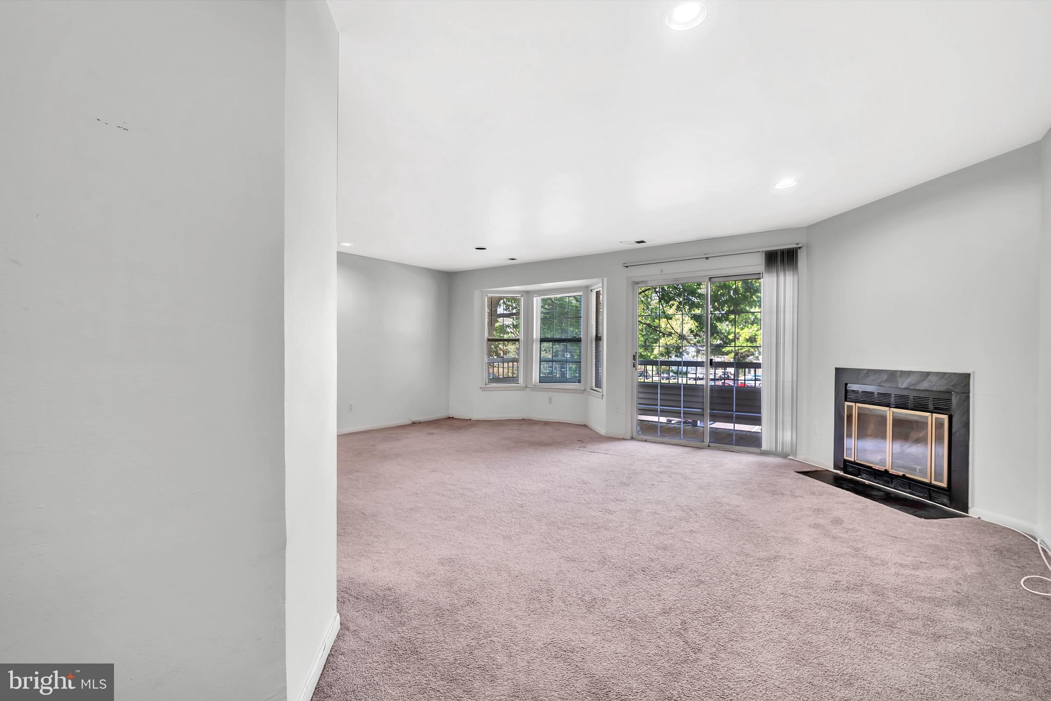 302 Trinity Court, Unit 8 Princeton, NJ 08540 - Photo 4 of 17 a view of an empty room with a fireplace and a window
