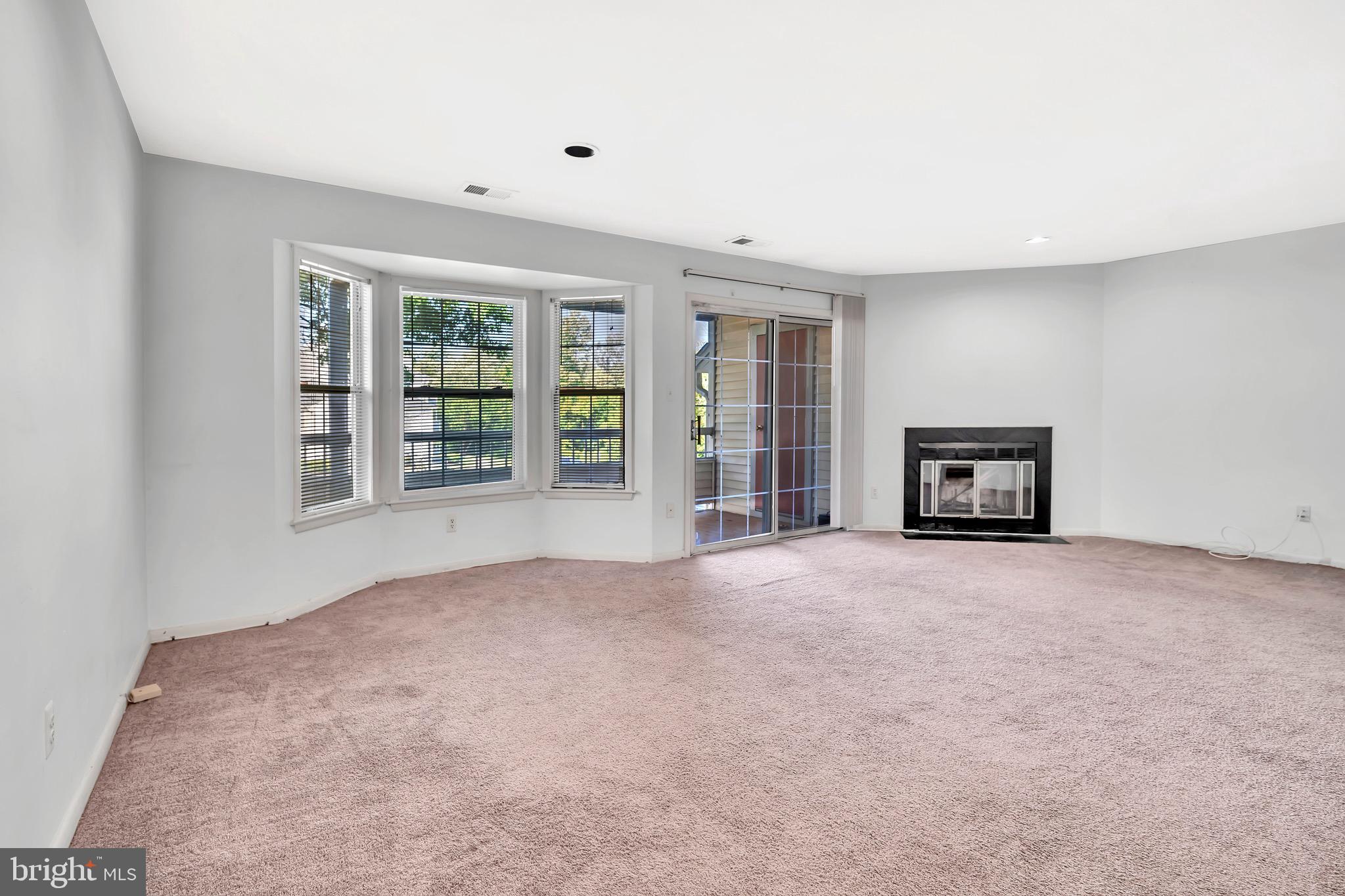 302 Trinity Court, Unit 8 Princeton, NJ 08540 - Photo 6 of 17 an empty room with a window and fireplace