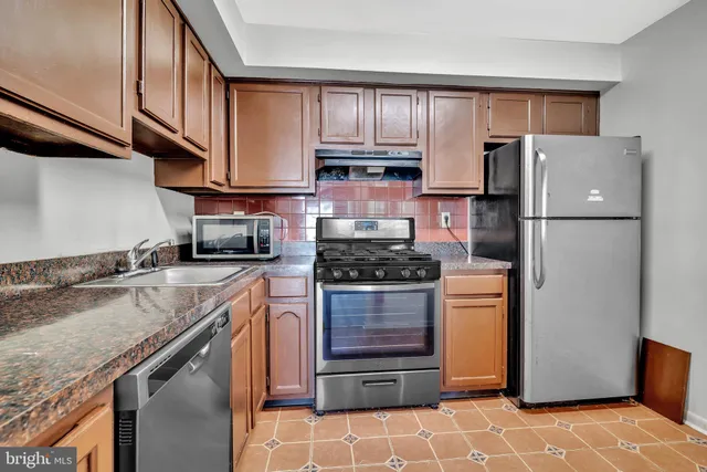 a kitchen with a refrigerator sink and stove