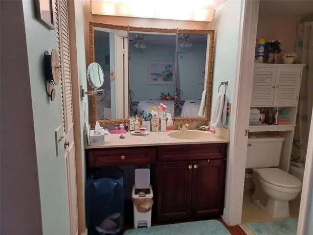a bathroom with a toilet sink and mirror