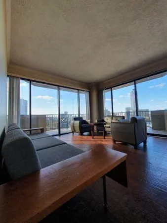 a living room with furniture and a large window