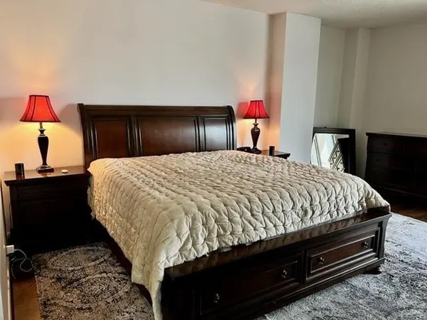 a bed sitting in a bedroom and dressers