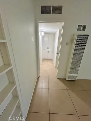 a view of a hallway to rooms