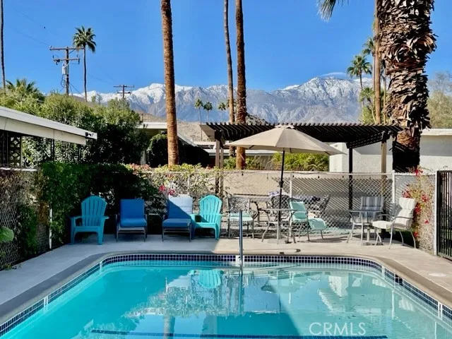 a view of swimming pool with chairs