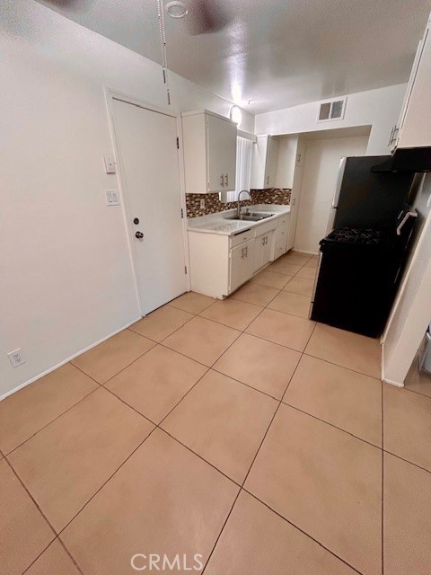 37111 Cathedral Canyon Drive, Unit 1 Cathedral City, CA 92234 - Photo 5 of 19 a kitchen with granite countertop a stove a sink and a refrigerator