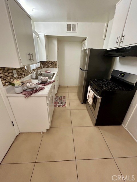 37111 Cathedral Canyon Drive, Unit 1 Cathedral City, CA 92234 - Photo 9 of 19 a kitchen with a sink a stove and a refrigerator