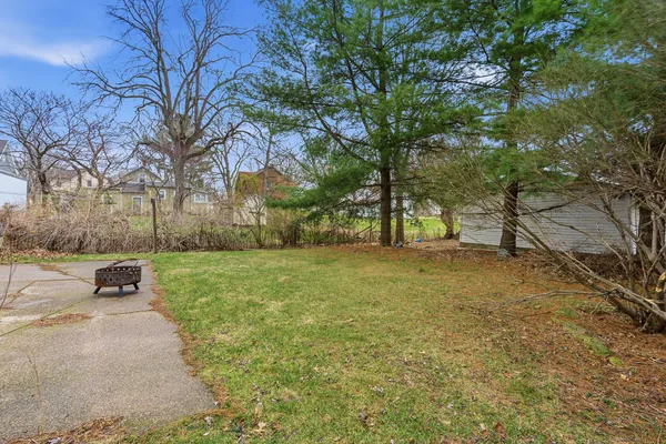 a swimming pool with outdoor seating and yard