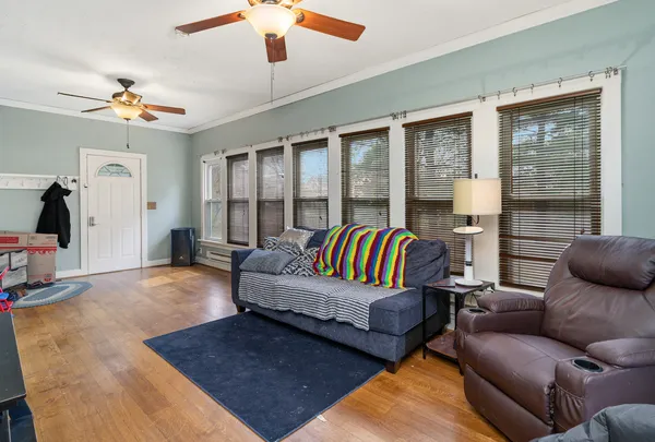 a bedroom with a bed a couch and a chandelier