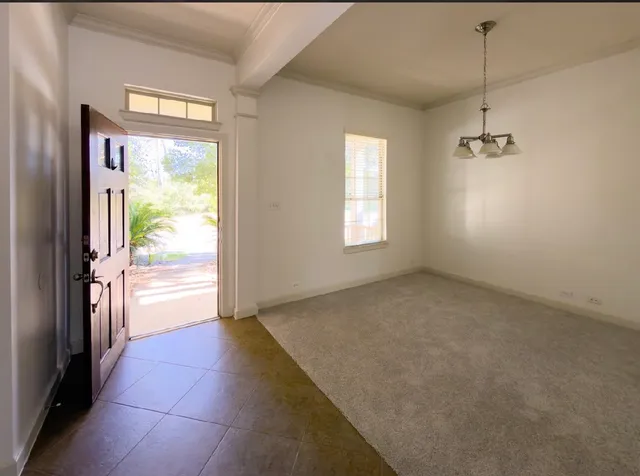 a view of an empty room and a window